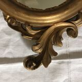 Golden oval mirror