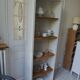 Shallow depth bookcase re-enchanted in pearl gray, wooden shelves.