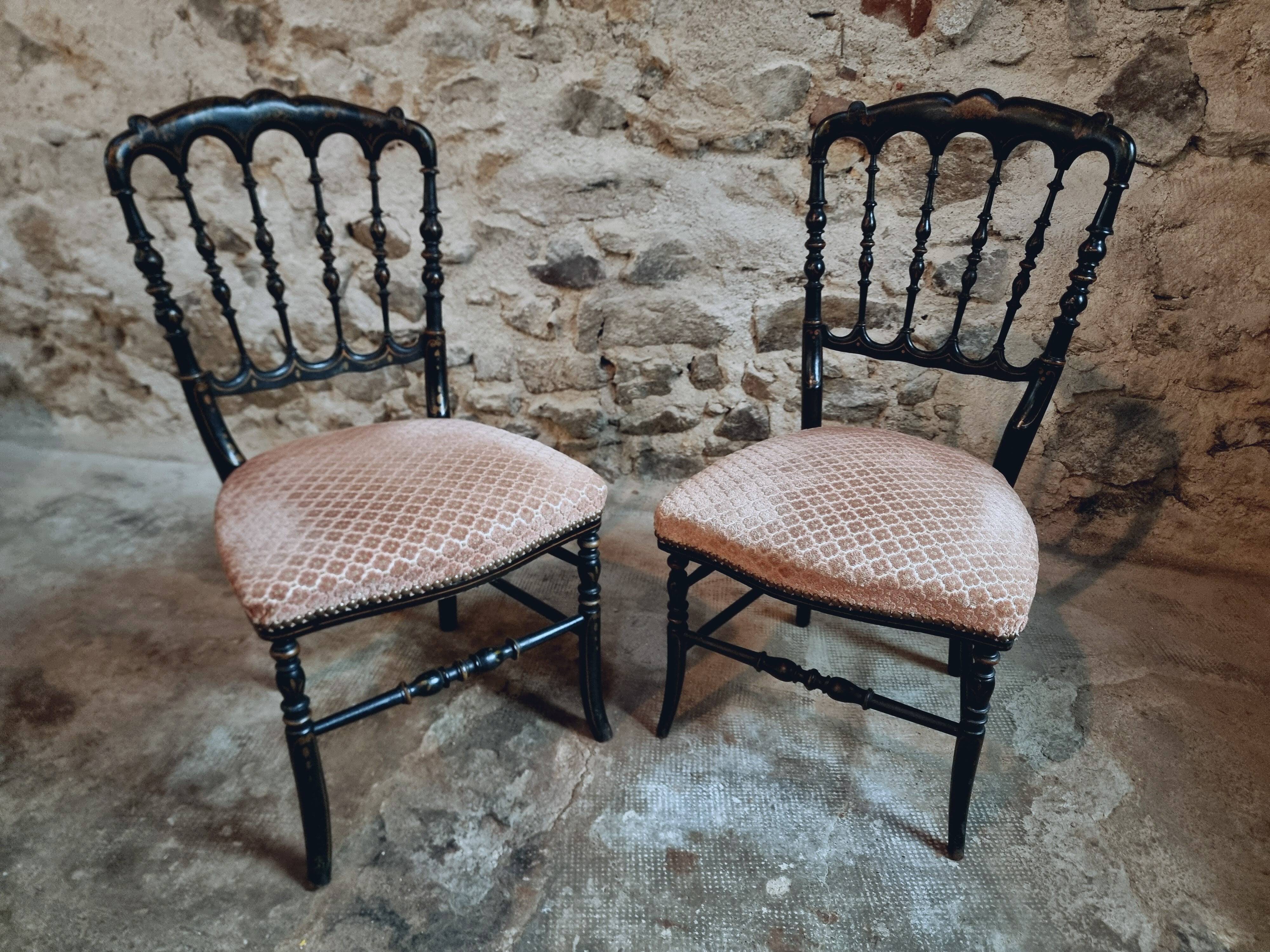 Pair of antique Napoleon III chairs in blackened wood and fabric.