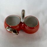 Porcelain salt shaker and orange pepper shaker decorated with a cicada