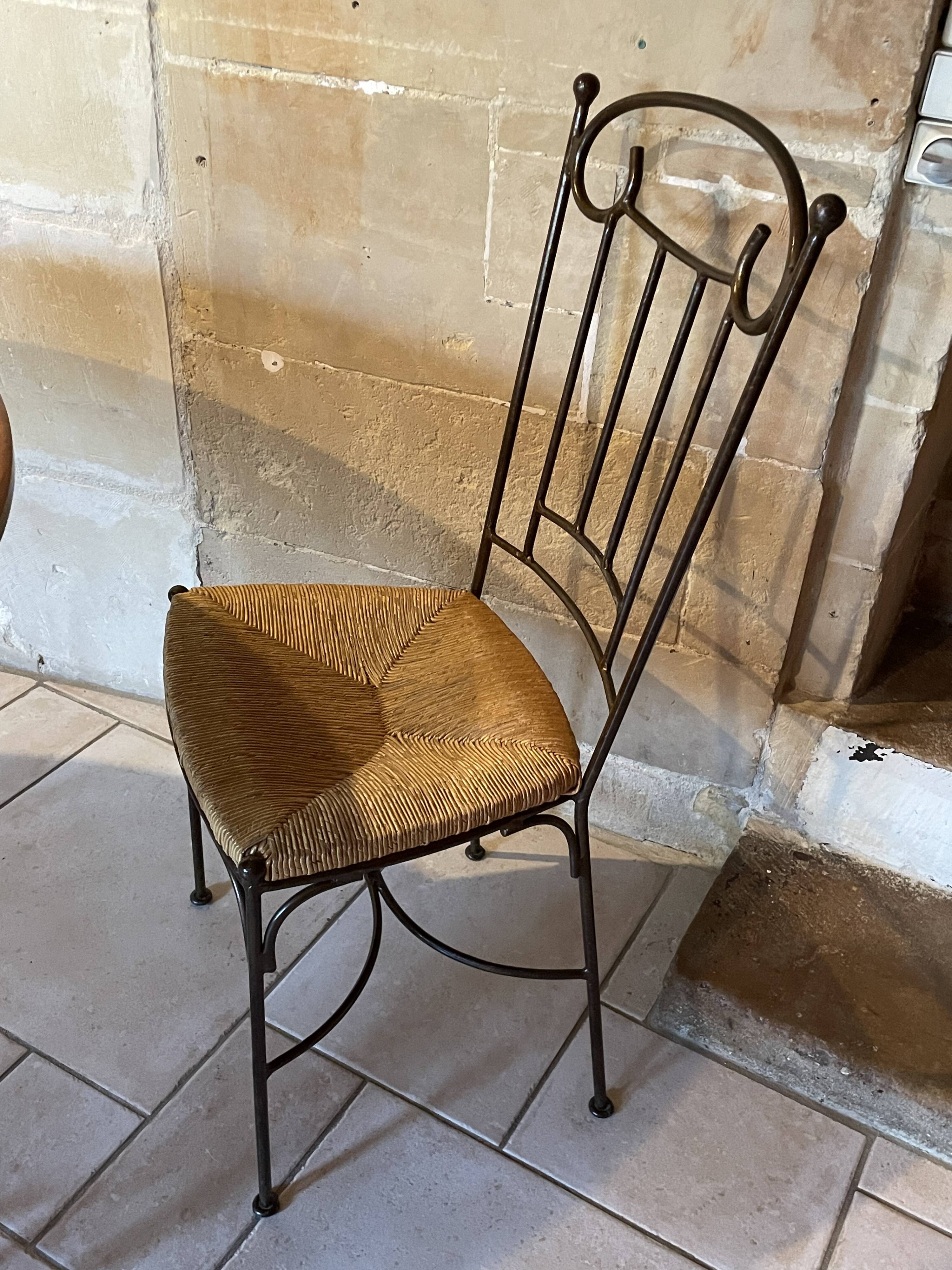 Table and four wrought iron and wood chairs.