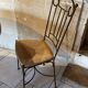 Table and four wrought iron and wood chairs.