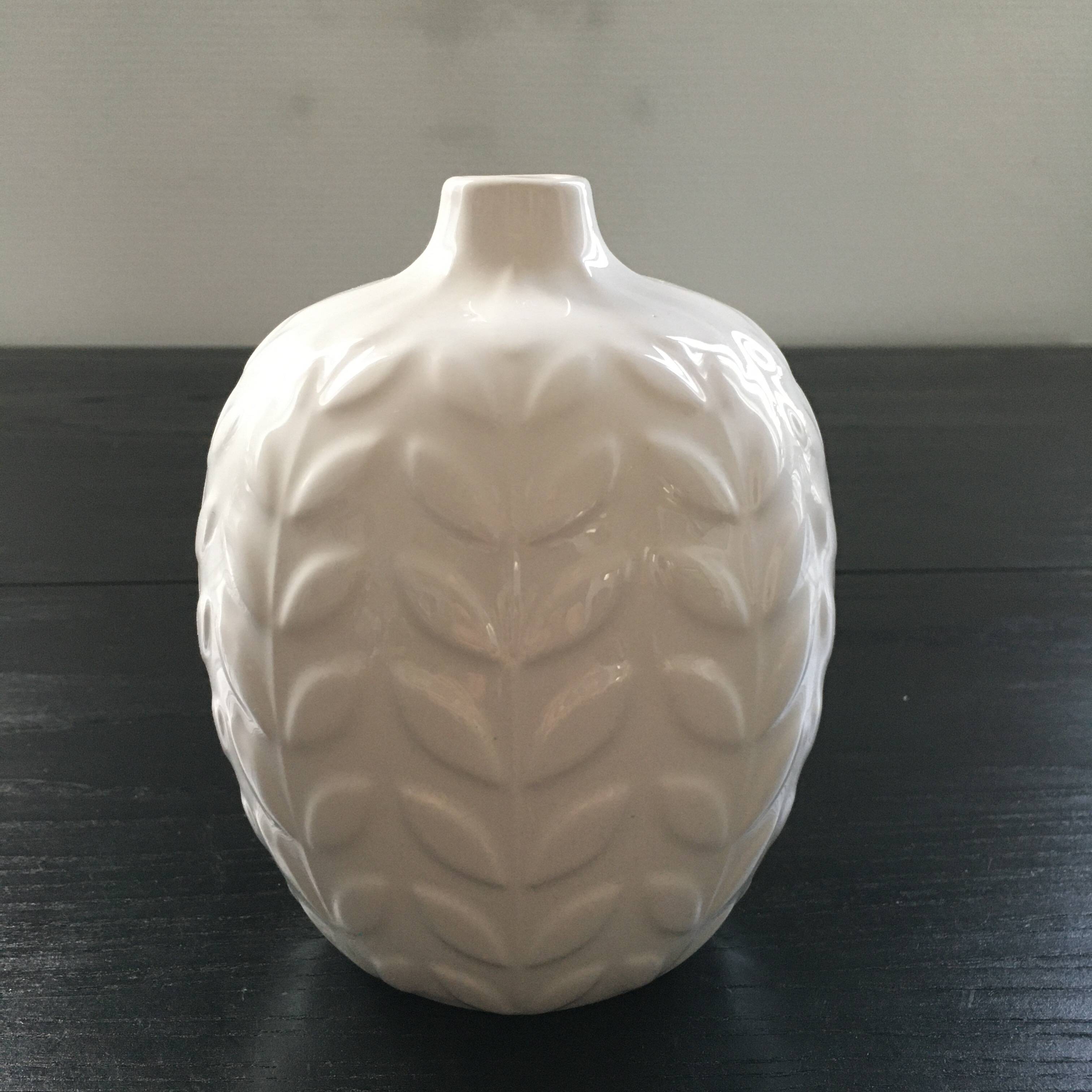 White vase with ear of corn decor