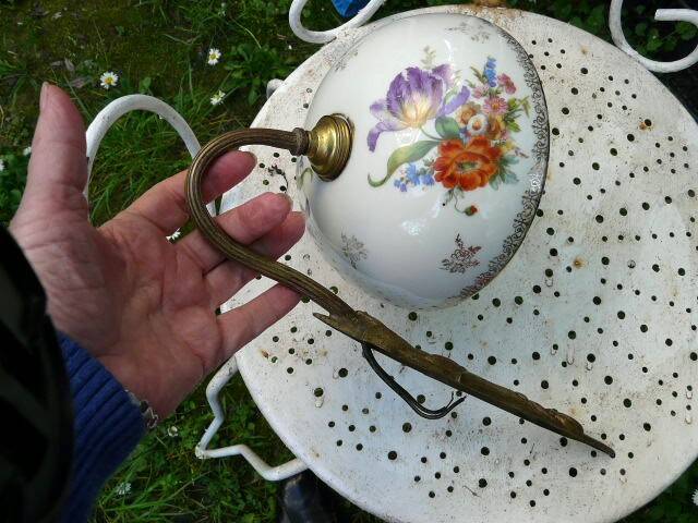Art Nouveau wall light in bronze with a white Haviland porcelain shade.