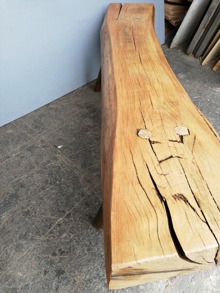 Big bench in solid rough wood very thick Brutalism
