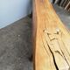 Big bench in solid rough wood very thick Brutalism