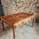 Antique French walnut table with six drawers, parquet top, early 20th century.