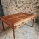 Antique French walnut table with six drawers, parquet top, early 20th century.