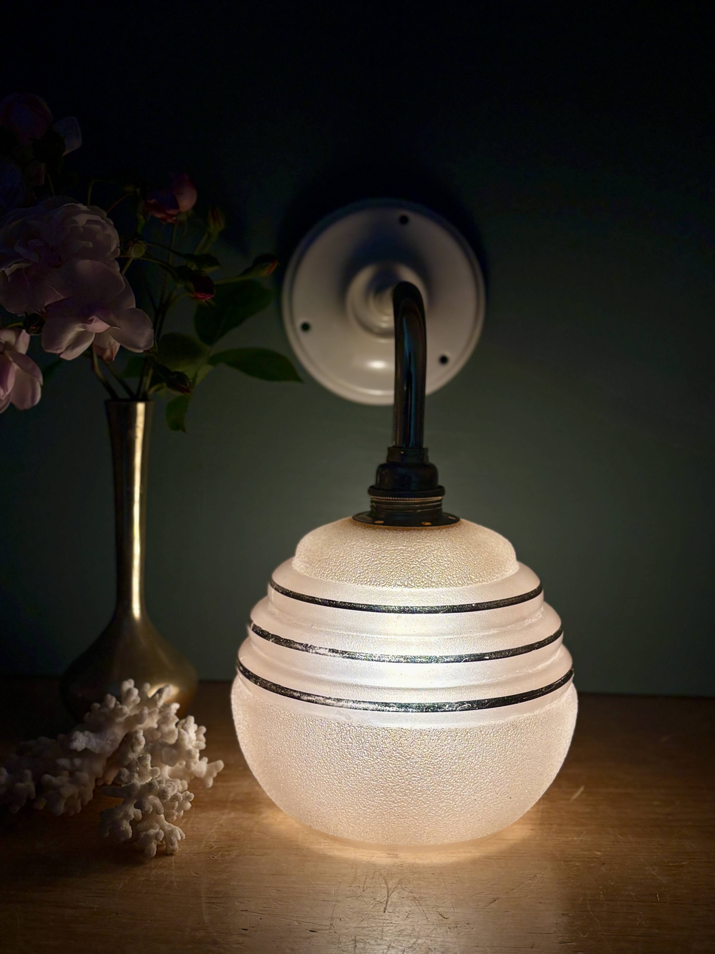 Vintage pink and gold frosted glass globe wall light.