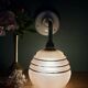 Vintage pink and gold frosted glass globe wall light.