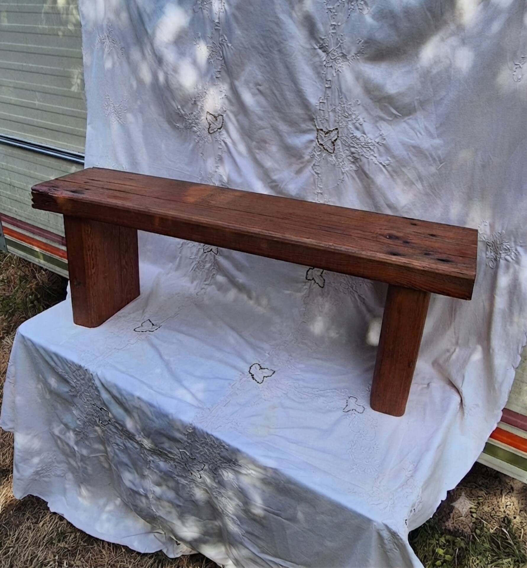 Brutalist wooden bench made of solid oak beam.