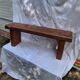 Brutalist wooden bench made of solid oak beam.