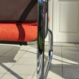 The 1970s orange armchair fabric and chrome metal