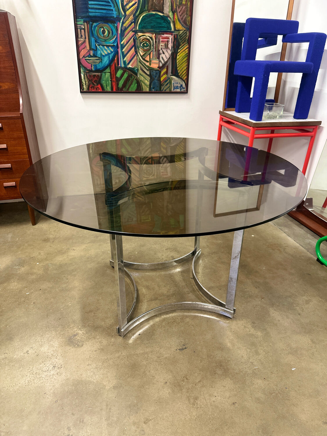 Dining table in chrome metal and smoked glass.