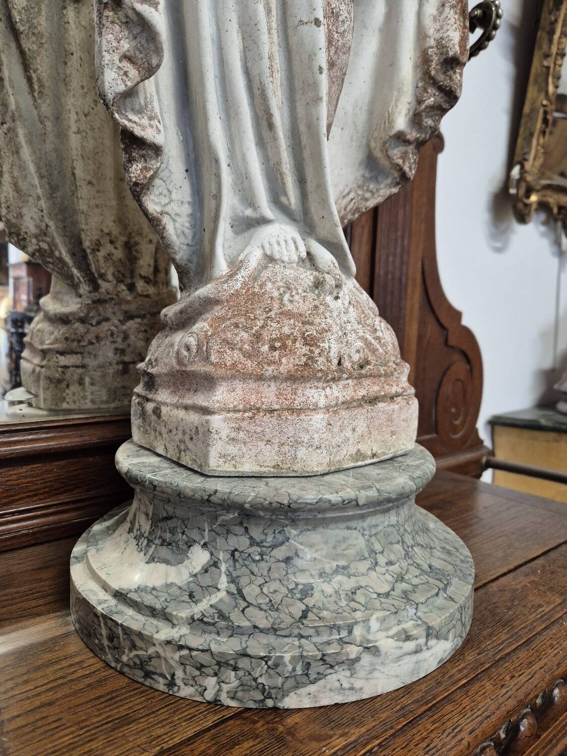 Garden statue of the Virgin Mary in old reconstituted stone