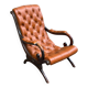Fauteuil Chesterfield en cuir et bois massif sculpté