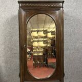 Renaissance style oval mirror cabinet in solid walnut circa 1850