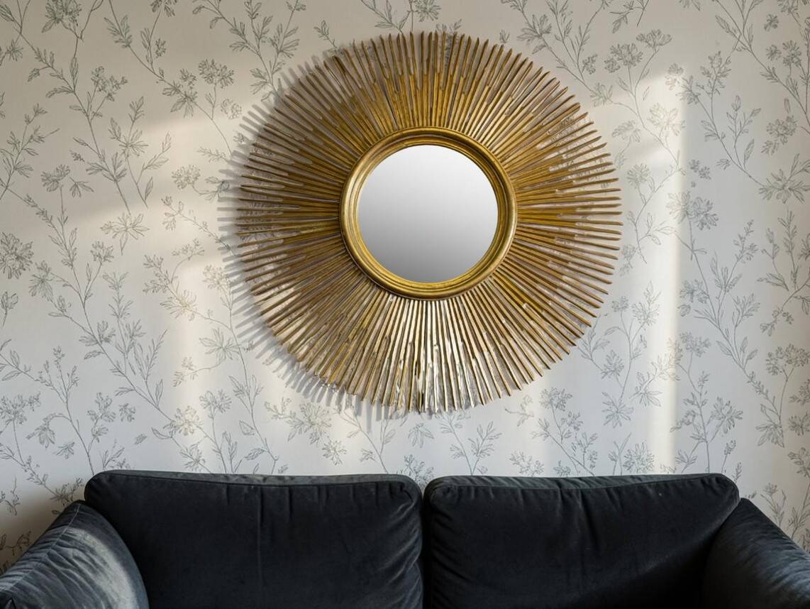 Large sunburst mirror with beveled glass and gilded wood from around 2010.