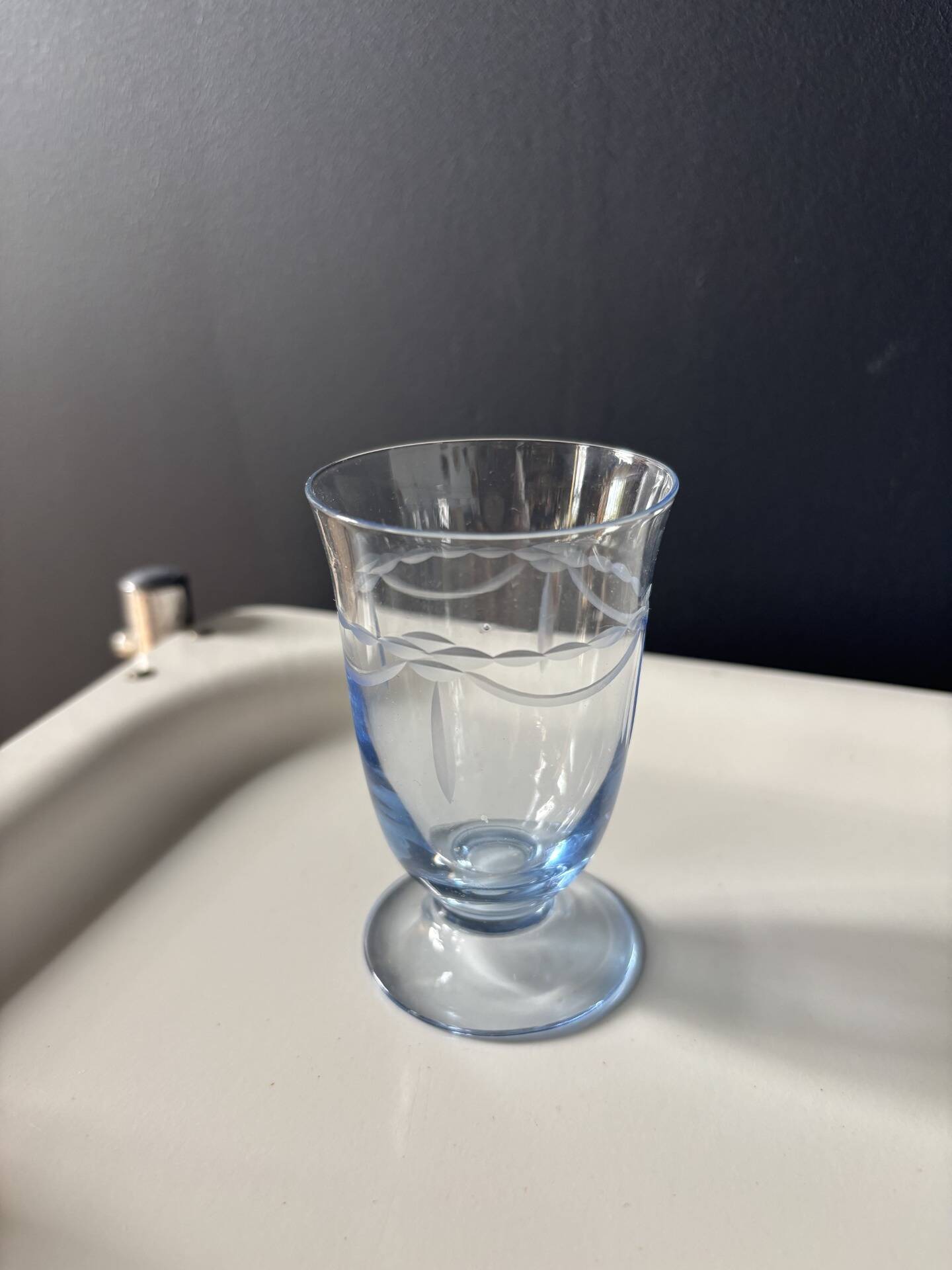 Set of 32 vintage glacier blue engraved stemmed glasses.