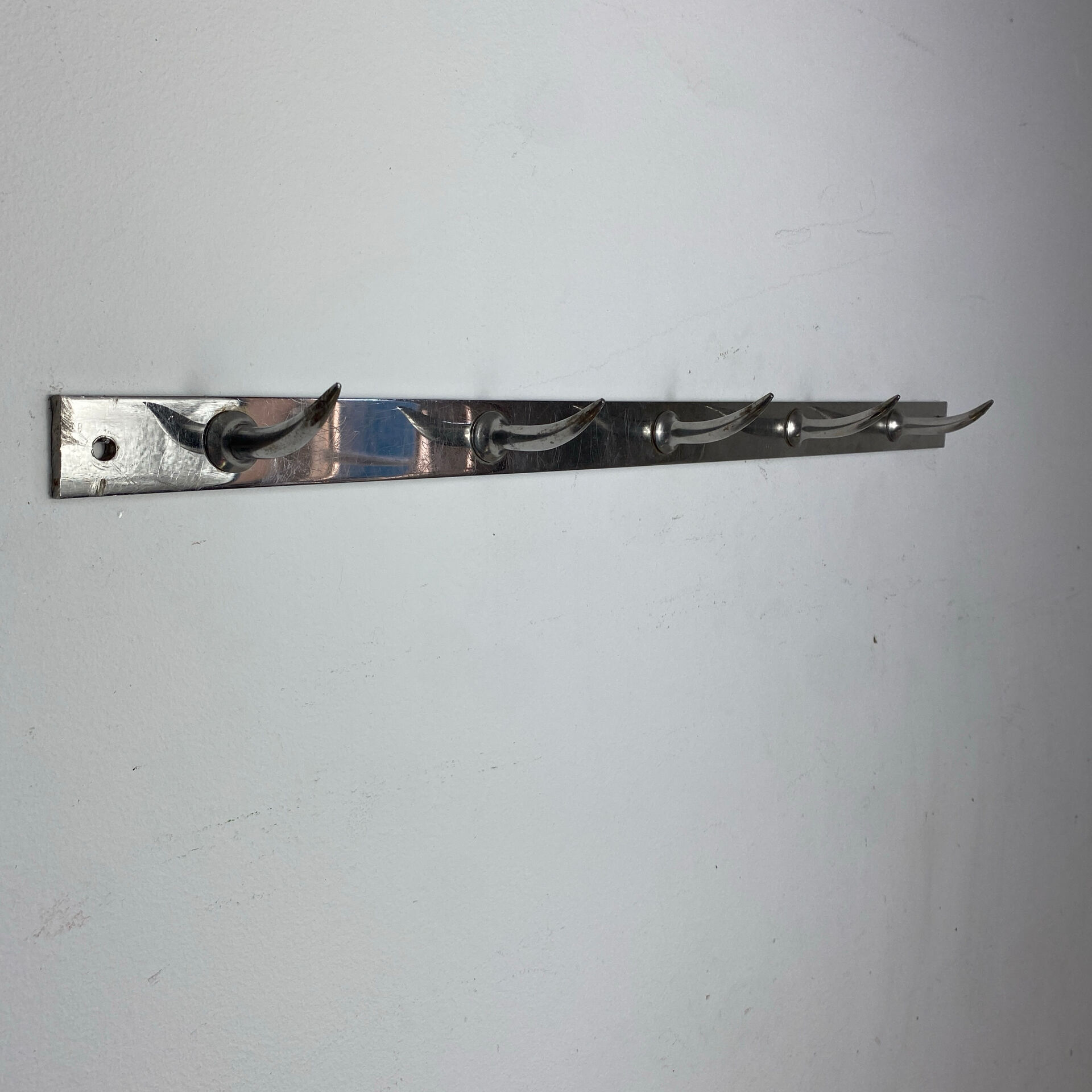 Stainless steel butcher's hook, known as a "wolf tooth bar."