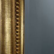 Baroque mantel mirror in carved wood and gilded plaster, France circa 1850.