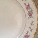 Flat old plates mismatched with flowers