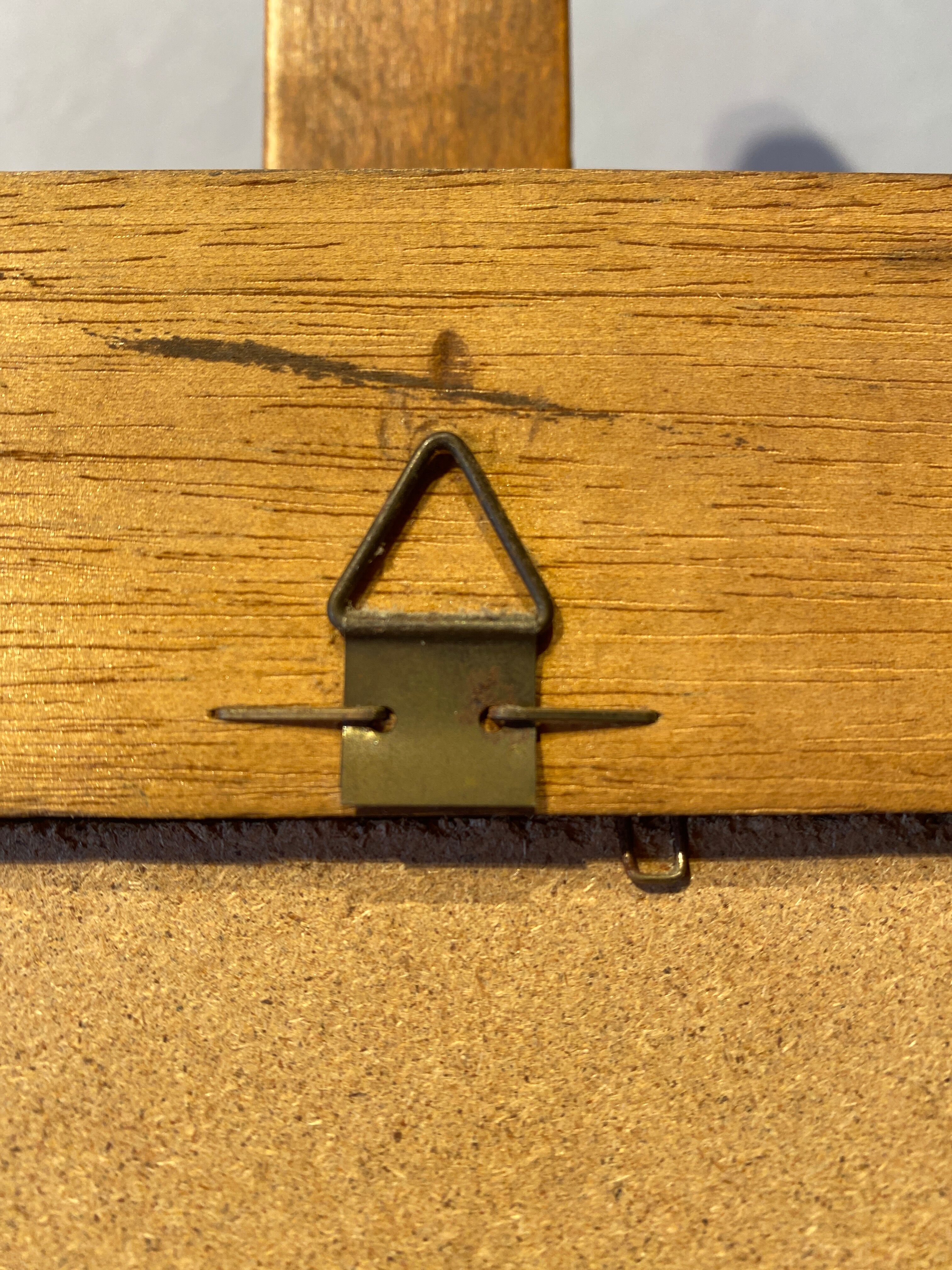 Beveled mirror in its wooden frame