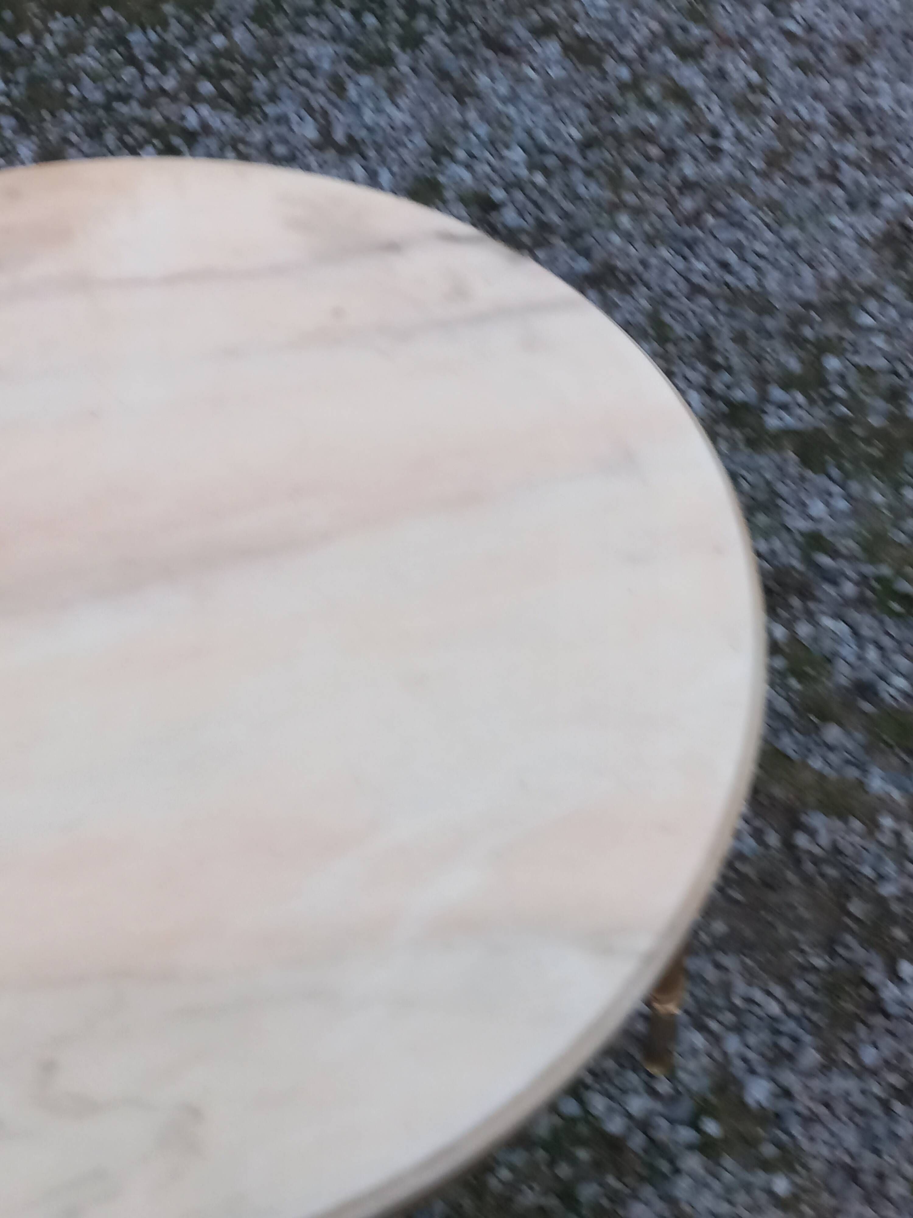 Round neoclassical coffee table with a marble top and golden metal base.