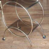Service console with design / gilded metal wheels and smoked glass