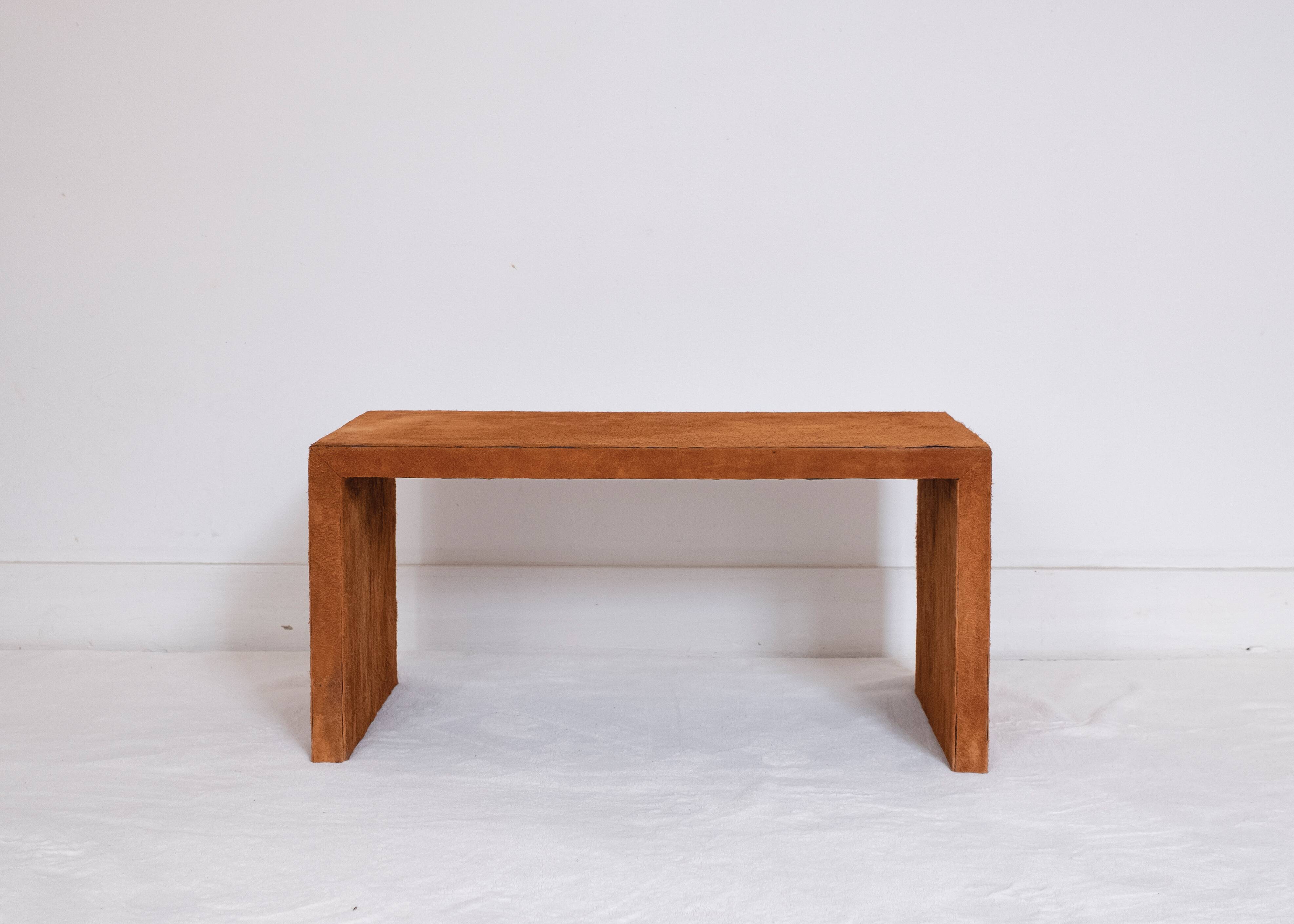 Pair of cognac suede side tables in the style of Jean Michel Frank.
