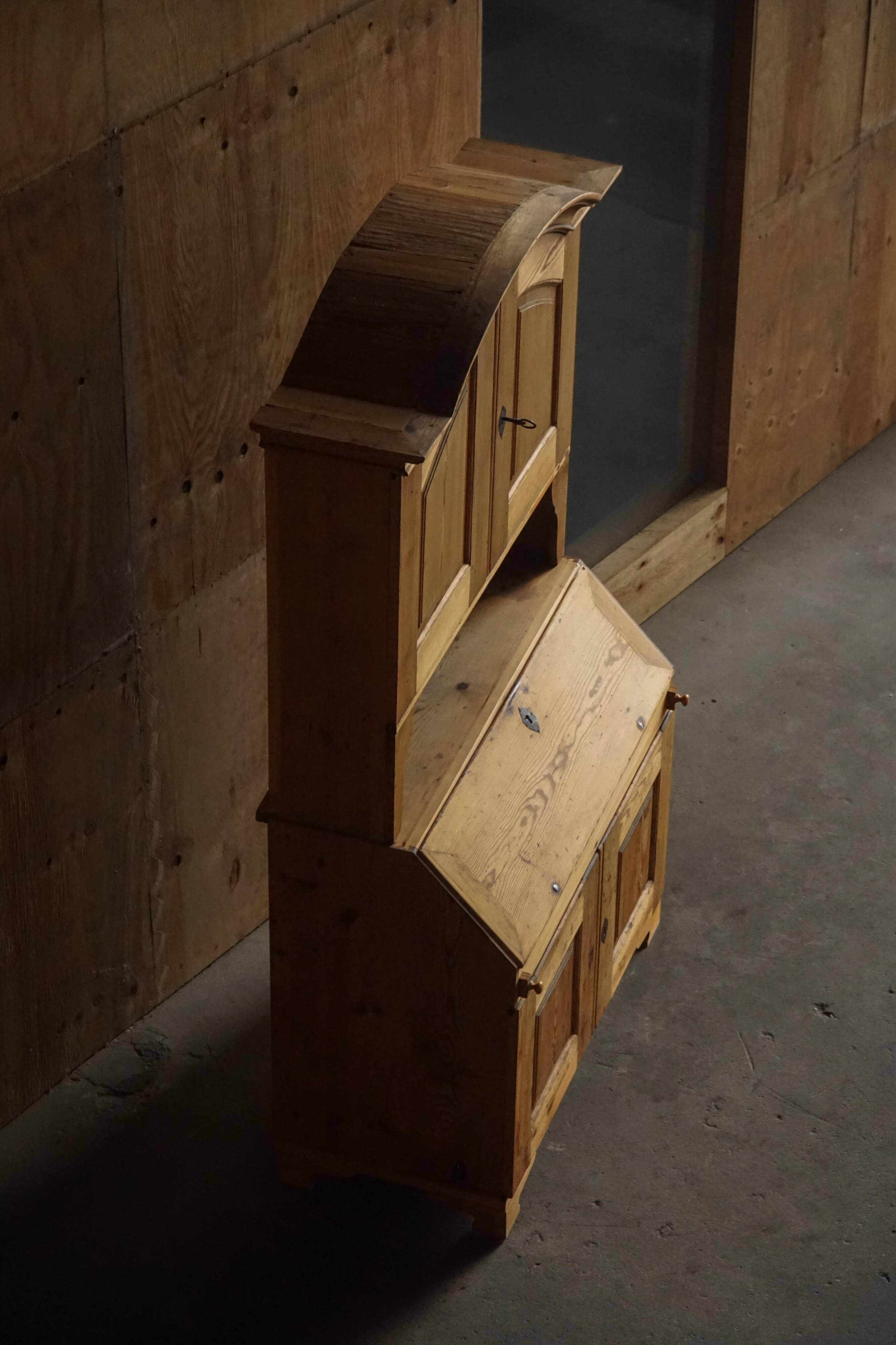 Old Danish secretary in pine with drop-down front and upper cabinet, mid-19th century.