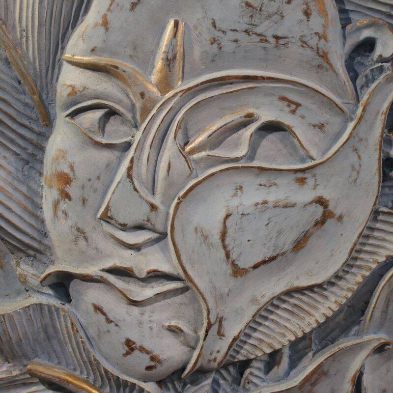 Bas-relief sculpture, stylized face with flowers, 20th century