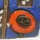 Ceramic relief in attractive blue with a motif of white/red flowers.