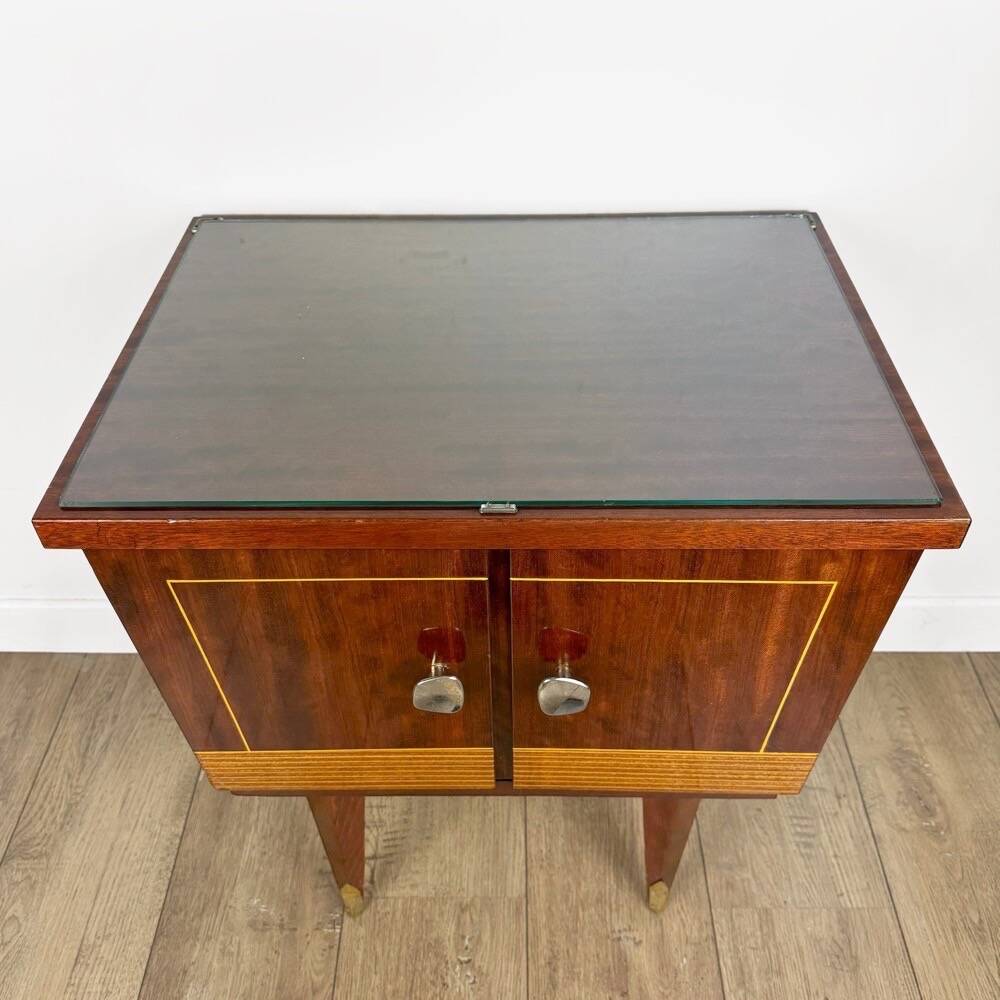 1950s bedside table in varnished wood veneer and brass.