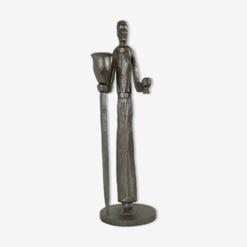 Vintage wrought iron candle holder by Gisbert depicting a man holding a candle and a mug