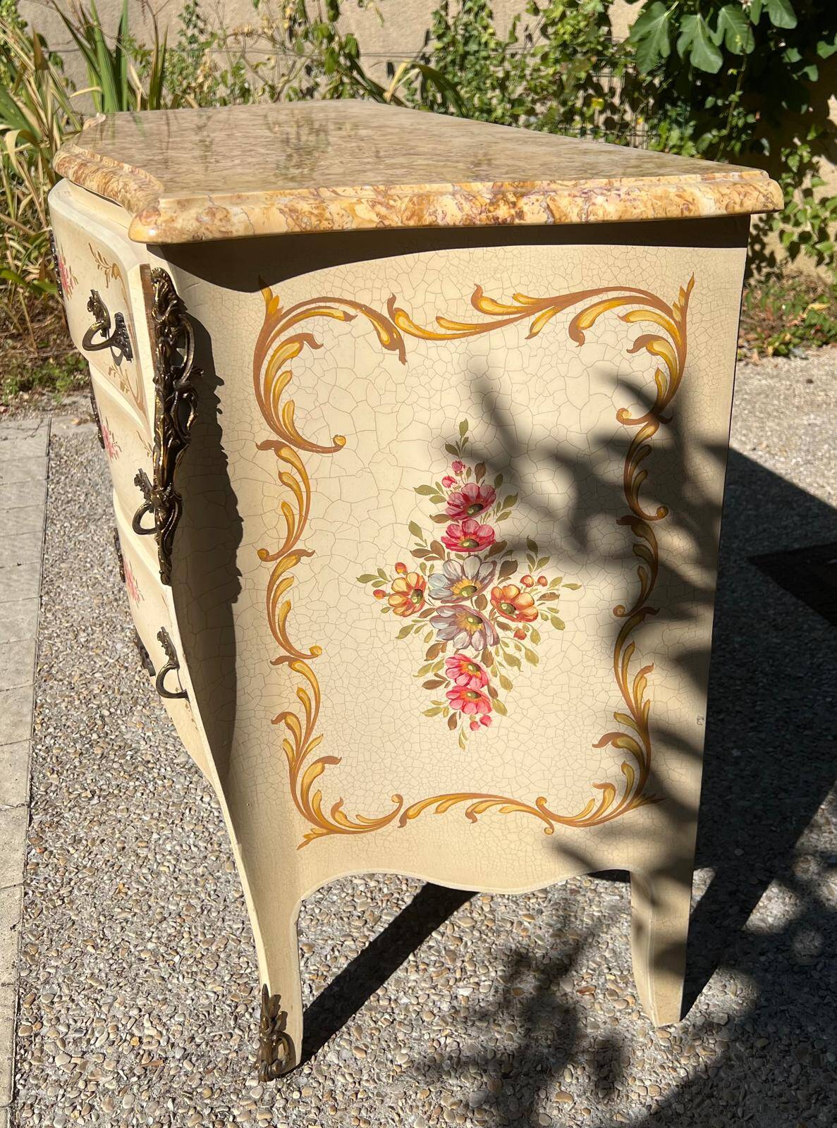 Curved Louis XV style commode in marble with painted floral decoration.