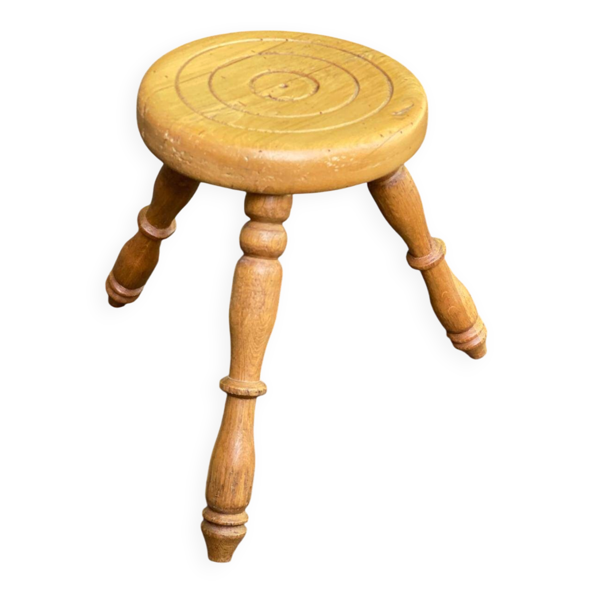 Vintage low tripod stool with carved light oak legs.