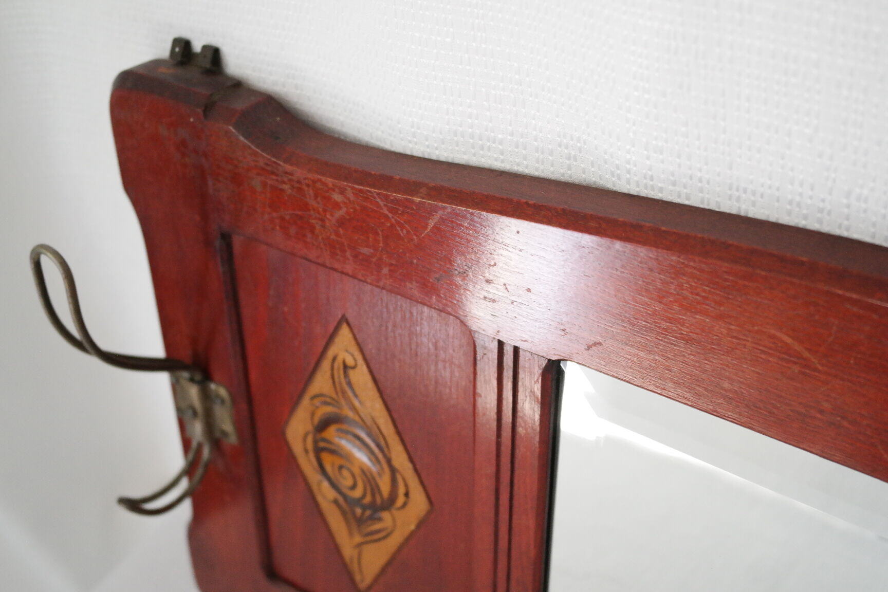 Red wooden wall-mounted coat rack and Art Deco mirror