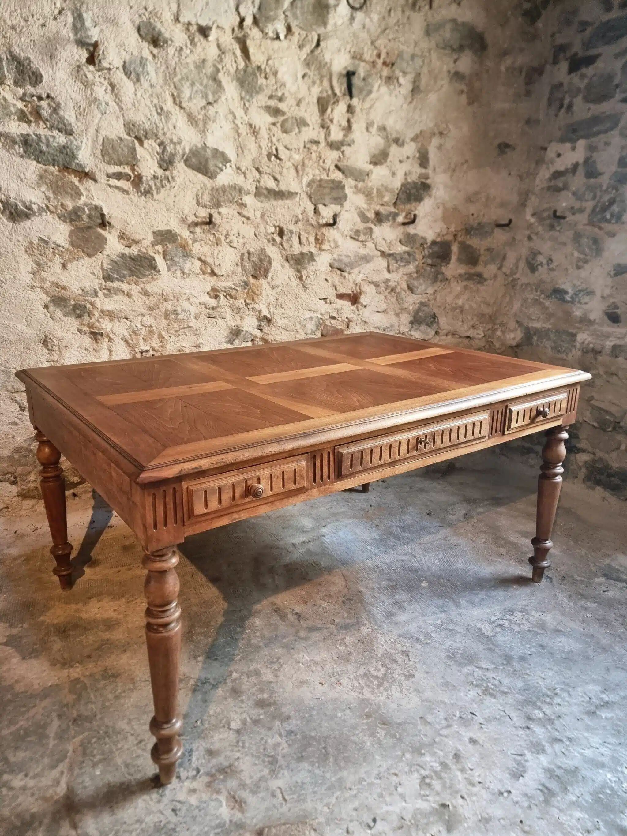 Antique French walnut table with six drawers, parquet top, early 20th century.