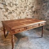 Antique French walnut table with six drawers, parquet top, early 20th century.