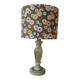 Table lamp with light green onyx base, fabric shade with a khaki background.
