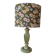 Table lamp with light green onyx base, fabric shade with a khaki background.