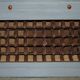 Vintage wooden furniture for 45 wine bottles with a drawer.