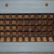 Vintage wooden furniture for 45 wine bottles with a drawer.