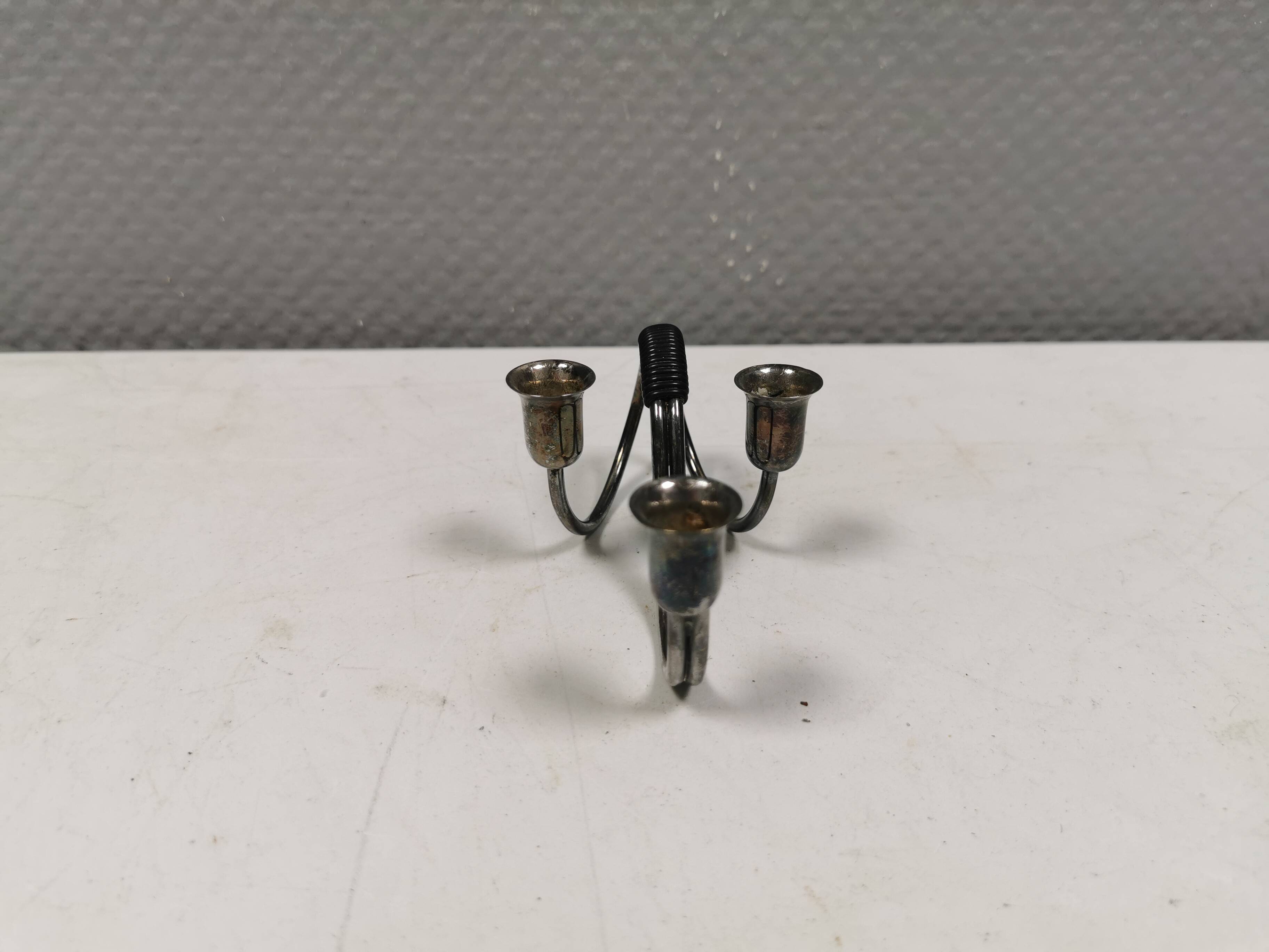 Small candle holder in tarnished silver, with place for three small candles