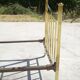 Antique gold-plated brass bed for one person.