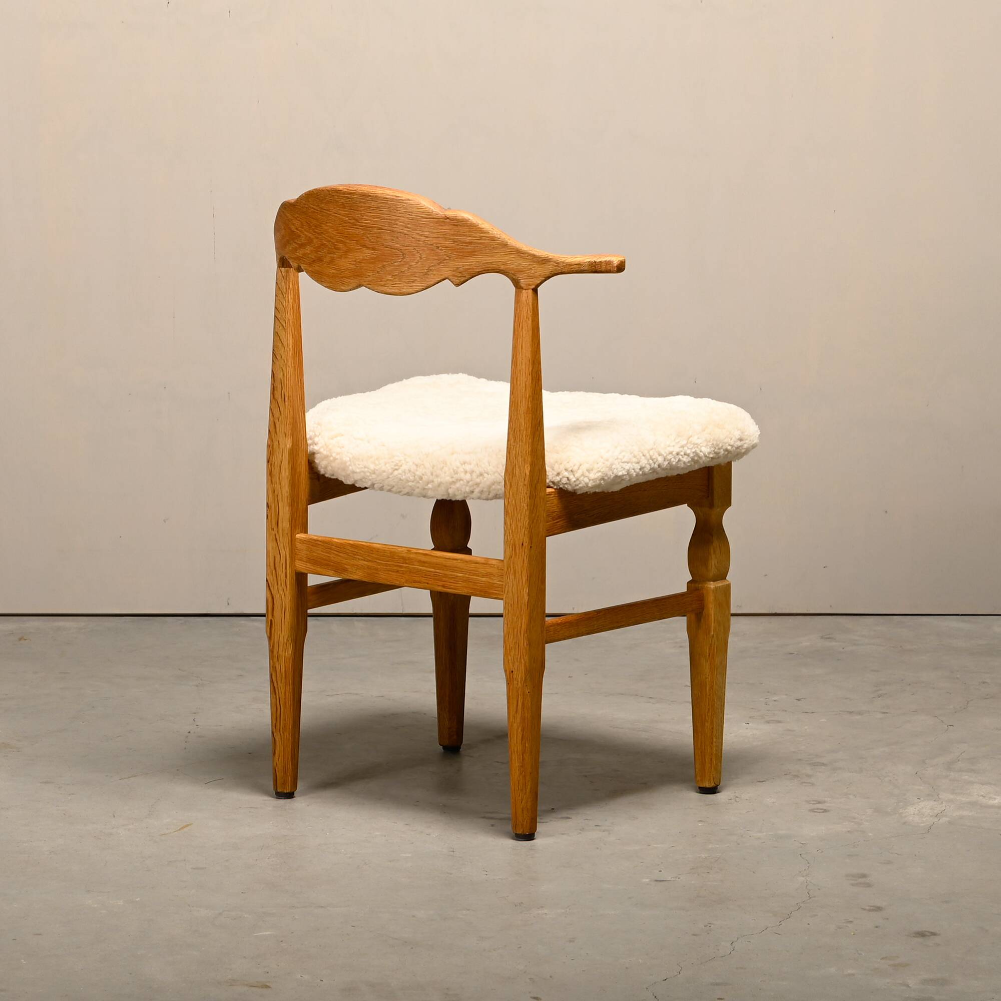 Henning Kjærnulf dining chairs set in Oak and Sheepskin, Denmark, 1960s