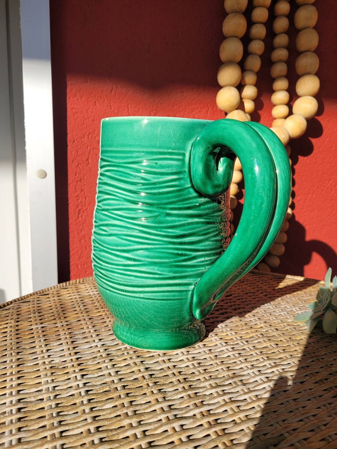 Green glazed ceramic pitcher