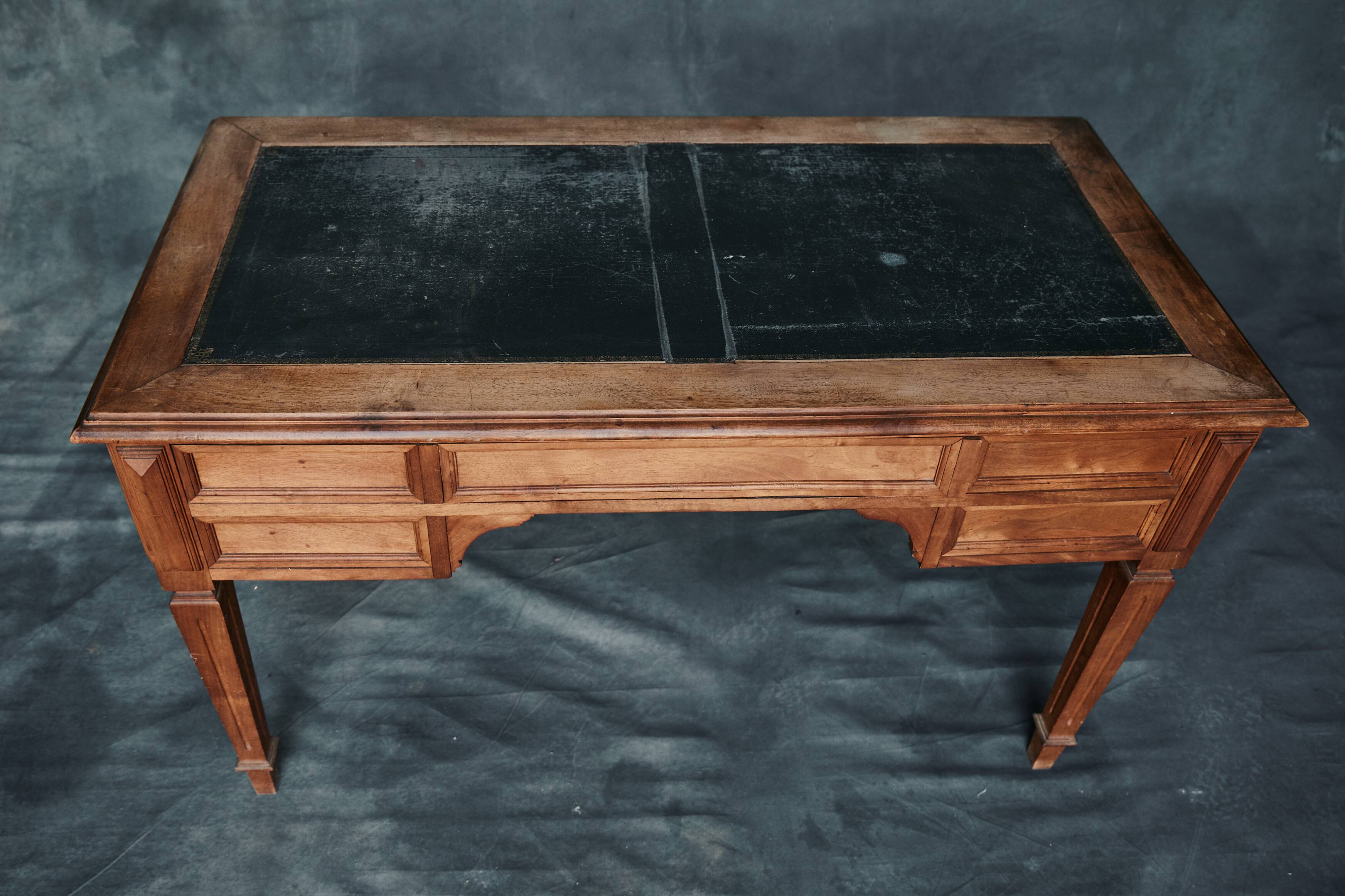 Antique wooden desk with upholstered top and 5 drawers