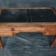 Antique wooden desk with upholstered top and 5 drawers
